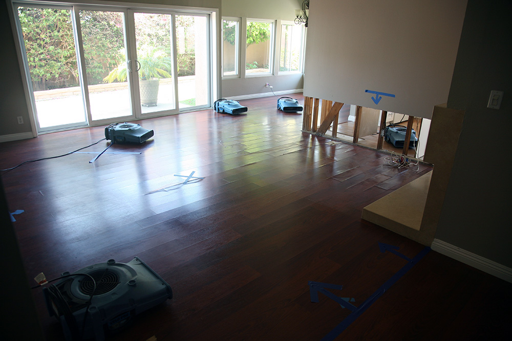 A wood floor being dried by multiple units as part of Bloomington flood cleanup and restoration services.