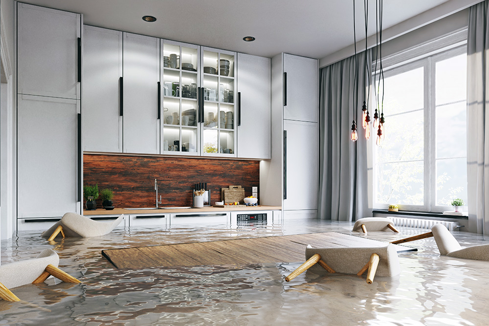 A flooded kitchen with chairs floating in need of flood cleanup near Colton, California.